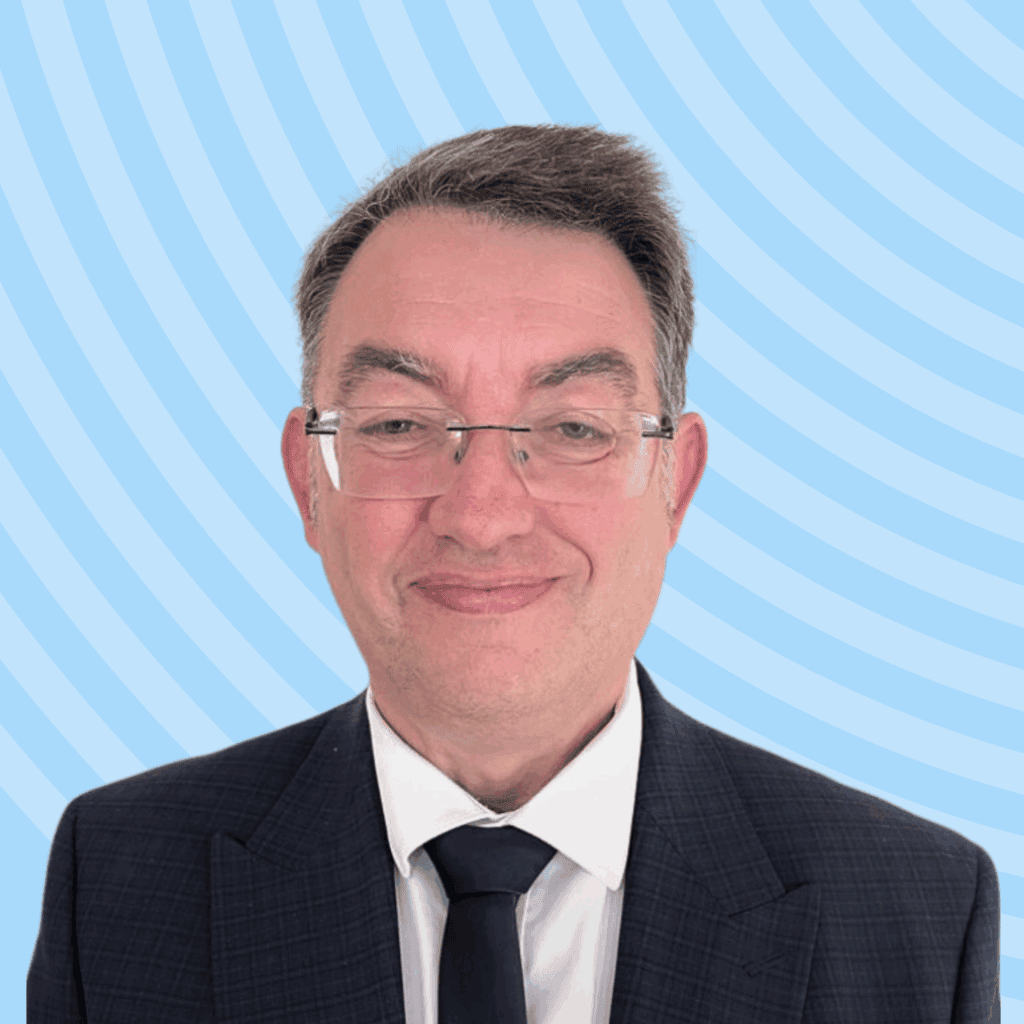 Stuart, a white male wearing a suit, against a plain background.